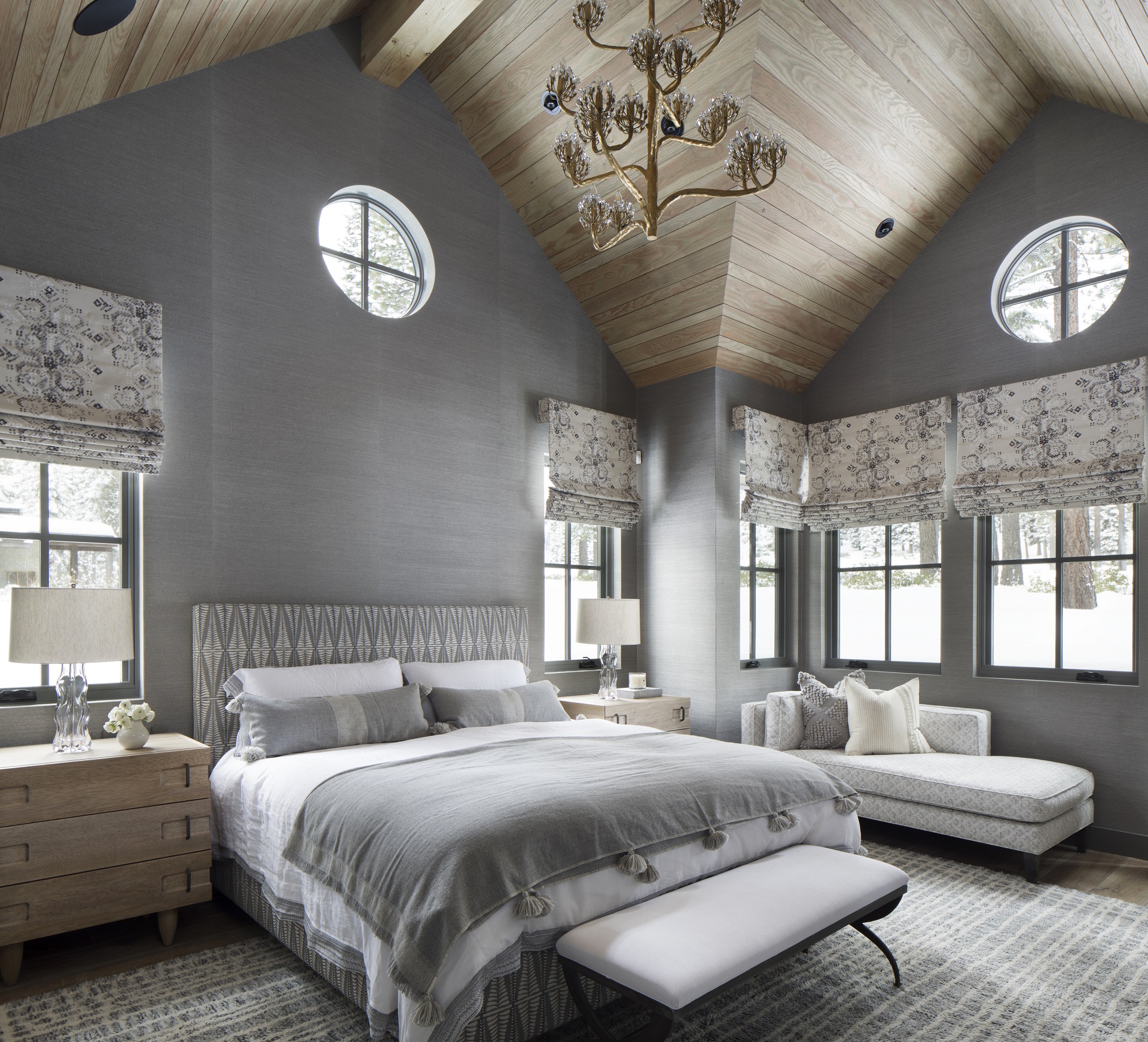 Patterned roman shades, grey upholstered headboard and custom linen bedding