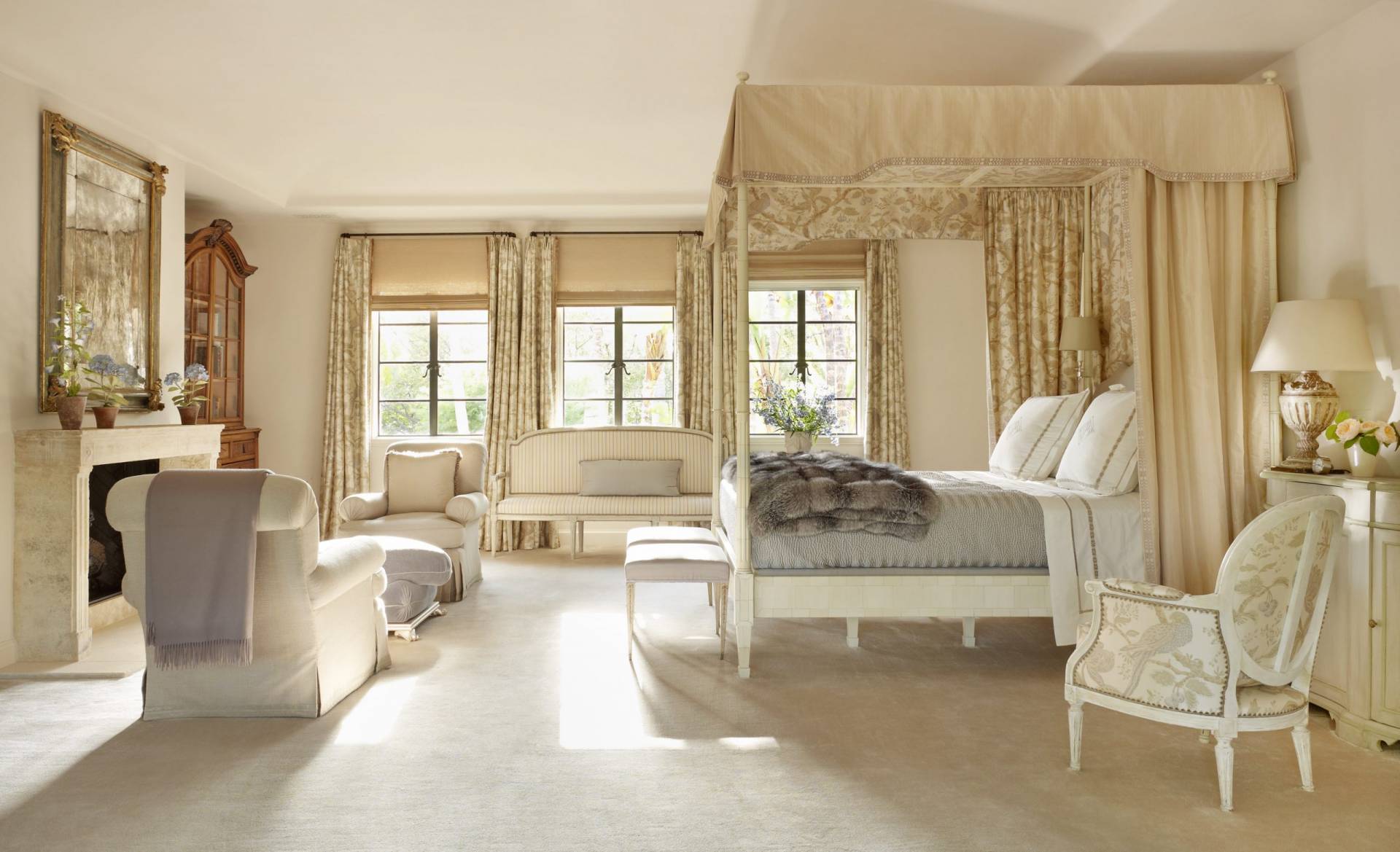Shades of gold bedroom with bed canopy, pleated drapery, roman shades, and upholstery